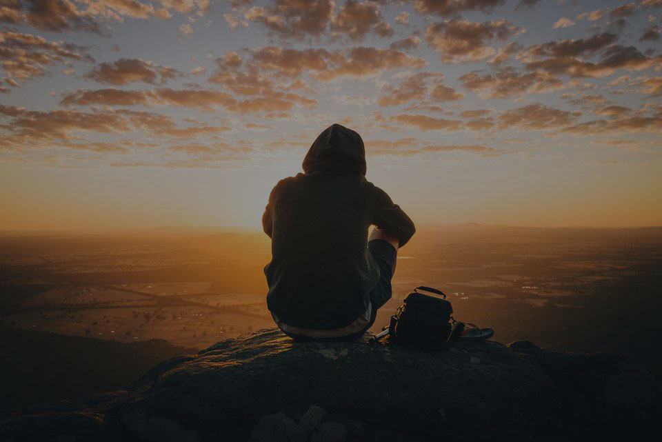 man on top of mountain after recovery