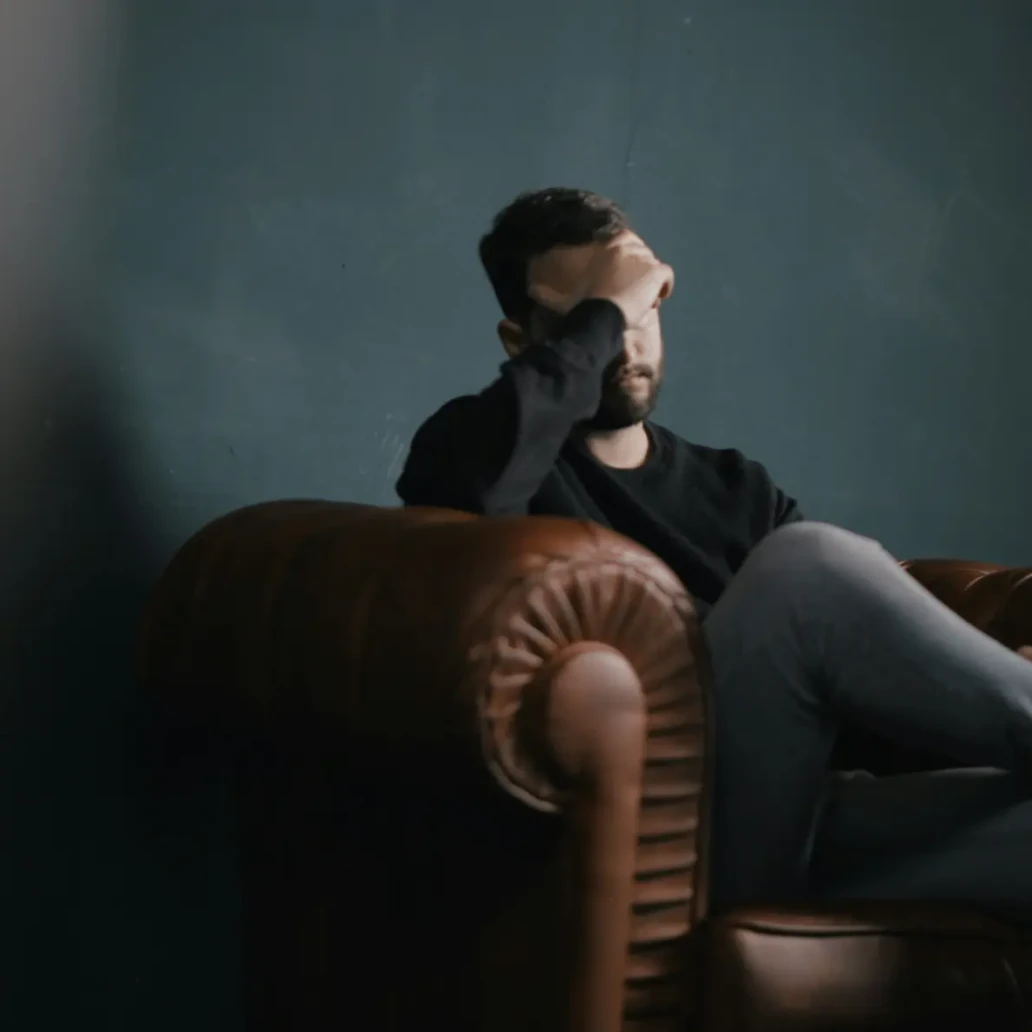Individual in outpatient addiction counselling session addressing stress and recovery